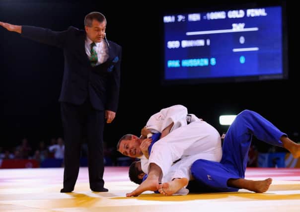 Euan Burton of Scotland, in white, defeats Shah Hussain Shah of Pakistan in the Men's +100kg Judo gold medal final. Picture: Getty