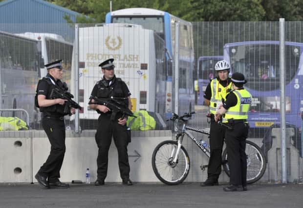 Armed police officers patrol a gate at the Commonwealth Games. Picture: PA