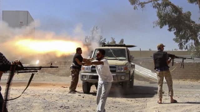 Fighters from the Islamist Misarata brigade fire towards Tripoli airport. Picture: AP