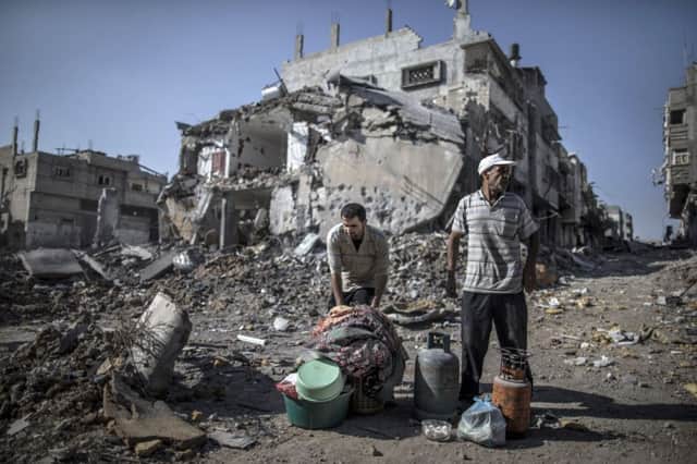Palestinians gather things they found in the rubble of destroyed buildings in Gaza. Picture: Getty