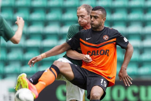 Dundee United's Mario Bilate holds off counterpart David Gray. Picture: SNS
