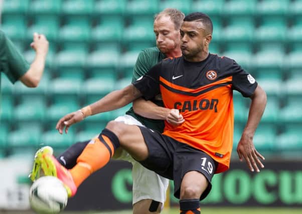 Dundee United's Mario Bilate holds off counterpart David Gray. Picture: SNS