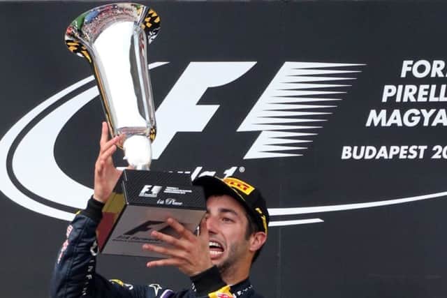 Daniel Ricciardo celebrates on the podium after winning the Hungarian Grand Prix. Picture: Getty