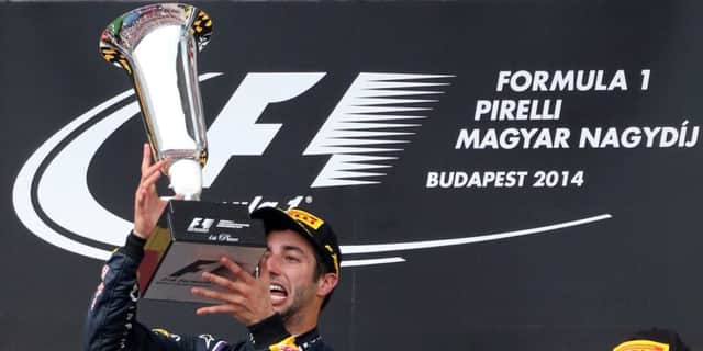 Daniel Ricciardo celebrates on the podium after winning the Hungarian Grand Prix. Picture: Getty