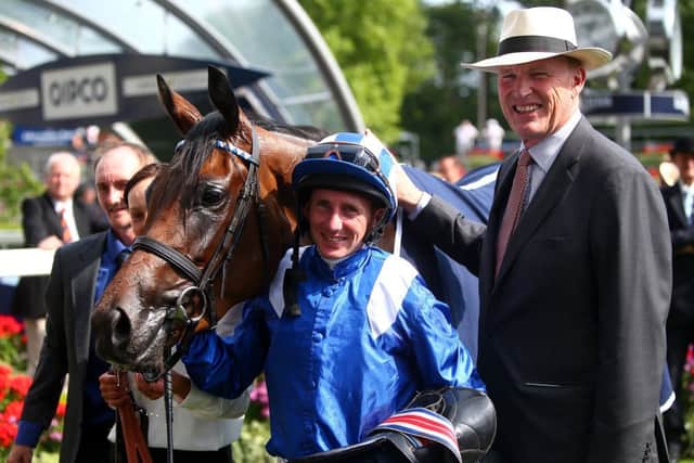 Paul Hanagan, centre, and John Gosden pose with Taghrooda after the victory. Picture: Getty