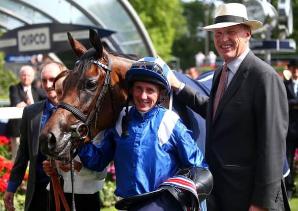 Paul Hanagan, centre, and John Gosden pose with Taghrooda after the victory. Picture: Getty