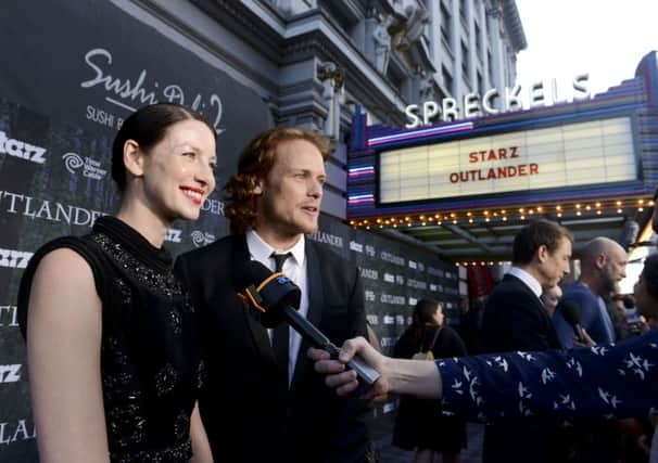 Captured on the red carpet co-star Caitriona Balfe and male lead Sam Heughan. Picture: Getty Images