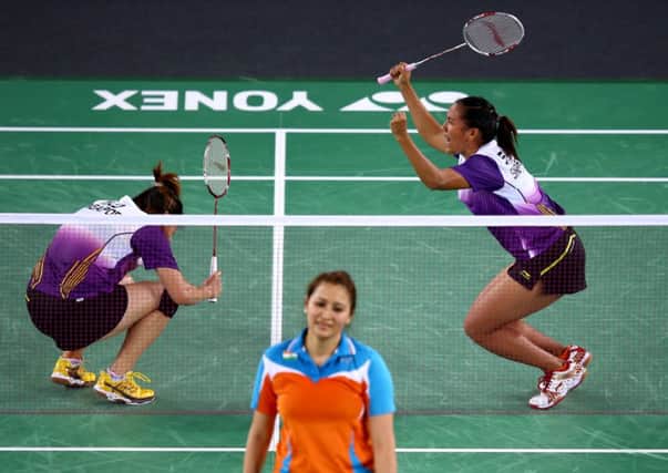 Singapore (top) celebrate victory in their women's doubles match over Ashwini Ponnappa and Jwala Gutta of India. Picture: Getty