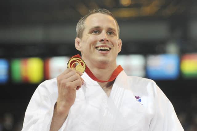 Euan Burton shows off his men's judo gold. Picture: Greg Macvean
