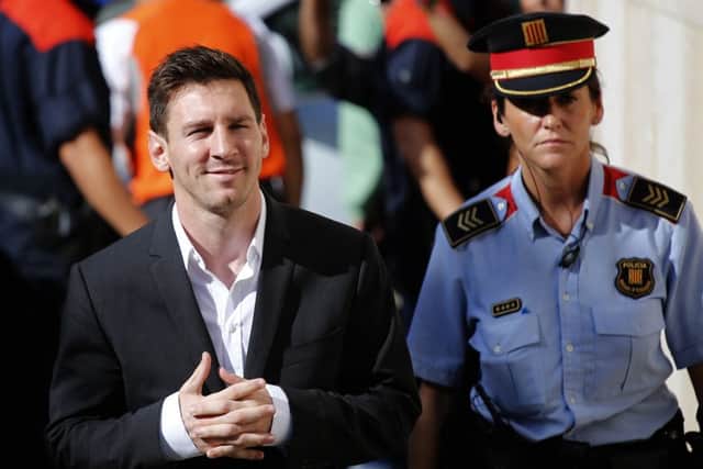 Barcelona star Lionel Messi, left, arrives at a court to answer questions in a tax fraud case in Gava, near Barcelona, Spain. Picture: AP