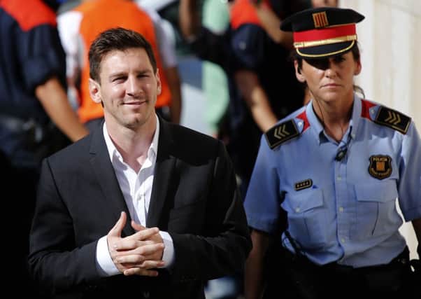 Barcelona star Lionel Messi, left, arrives at a court to answer questions in a tax fraud case in Gava, near Barcelona, Spain. Picture: AP