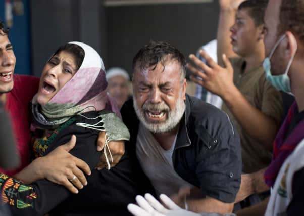 Palestinian mourners cry at Gaza City's al-Shifa hospital. Picture: Getty