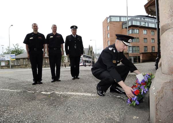 Chief fire officer Jimmy Campbell lays a wreath  to mark the second anniversary of death of firefighter Ewan Williamson. Picture: TSPL