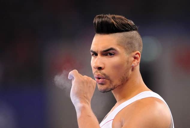 Louis Smith of England blows chalk from his hand during as he prepared to help his team into the lead on points. Picture: PA