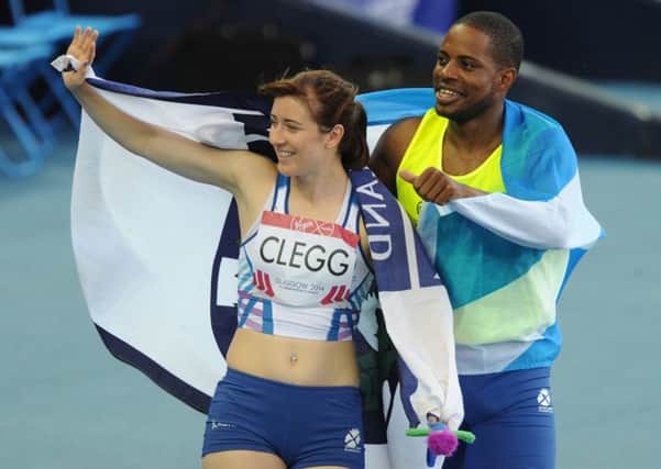 Scotland's Libby Clegg with guide runner Mikail Huggins after their win in the T11/12 100m. Picture: Neil Hanna