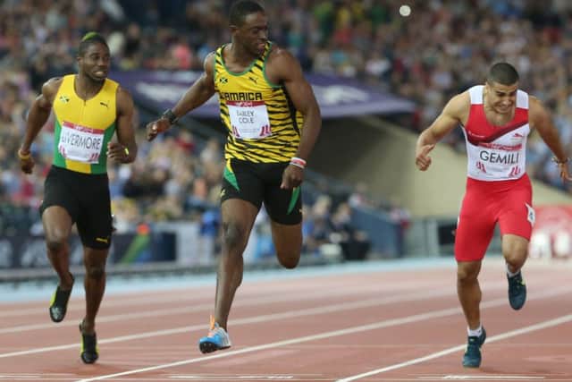 Kemar Bailey-Cole holds off Adam Gemili in the mens 100m. Picture: AP