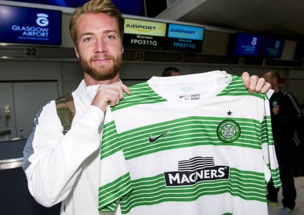 Jo Inge Berget just has time to pose with a Celtic shirt before jetting off to Warsaw. Picture: SNS
