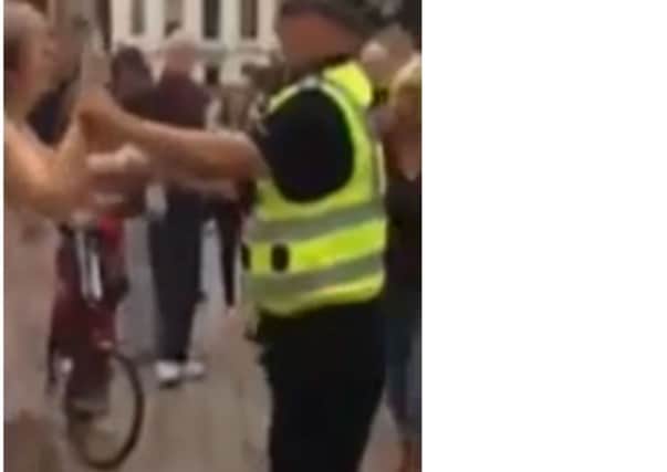 The policeman was filmed dancing to a Dean Martin song with a female passerby. Picture: Contributed
