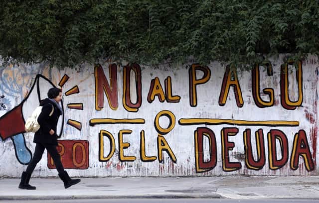 Graffiti on a wall in Buenos Aires reads No to the debt payment. Picture: Marcos Brindicci/Reuters