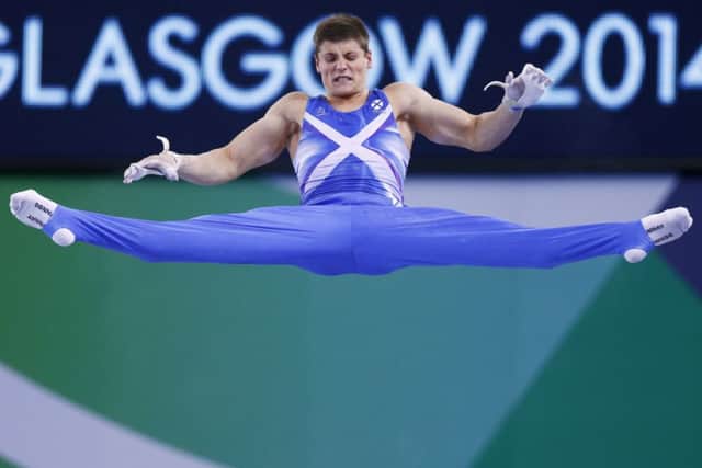 Frank Baines of Scotland performs his routine on the horizontal bar during the men's team apparatus final of the artistic gymnastics. Picture: Reuters