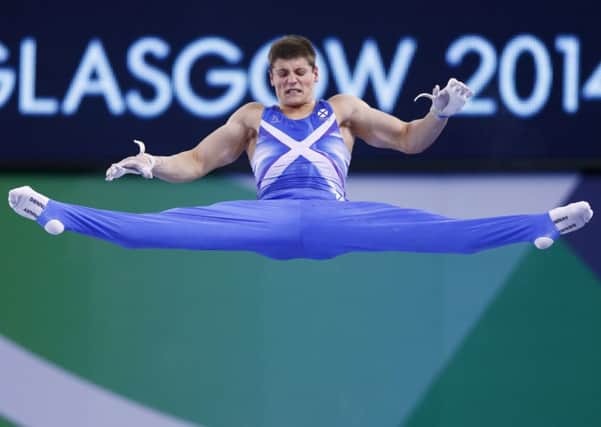 Frank Baines of Scotland performs his routine on the horizontal bar during the men's team apparatus final of the artistic gymnastics. Picture: Reuters