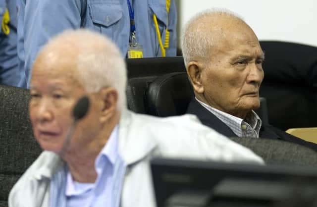 Khieu Samphan, left, and Nuon Chea, right, right-hand man to the group's late chief Pol Pot, sit in the court room. Picture: AP