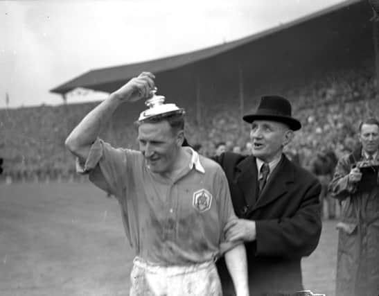 Alex Forbes trying on the FA Cup lid in 1950. Picture: PA