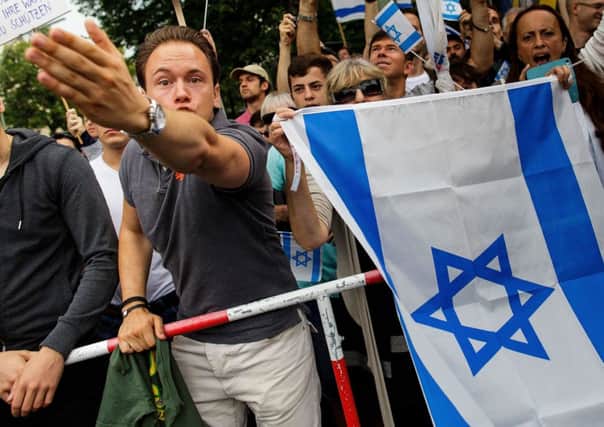 People with Israeli flags protest as a demonstration takes place in Berlin to express solidarity with the Palestinian people. Picture: Getty