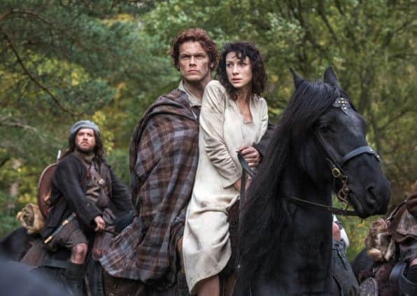 Claire Randall, right, and Sam Heughan as Jamie Fraser, and Grant O'Rourke as Rupert MacKenzie, in a scene from Outlander. Picture: AP