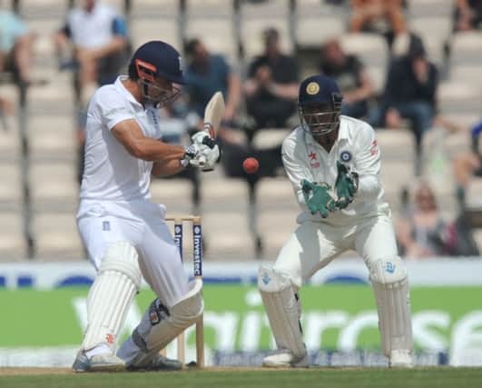 Alastair Cook shapes to cut, watched by Indian captain and wicketkeeper MS Dhoni. Picture: Getty