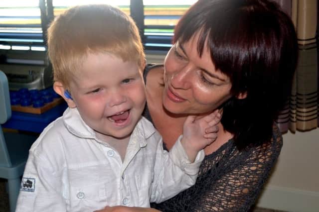 Lucy Cox with son Bo, who cant see or hear, needs dialysis four times a week, and has been in hospital for two years. Picture: Hemedia