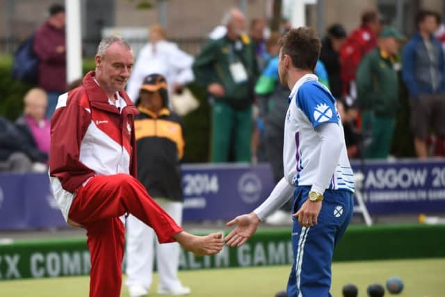 Scotlands Kevin Wallace and Englands Robert Love shake hands and feet at the end of their bowls match. Picture: Lorraine Hill