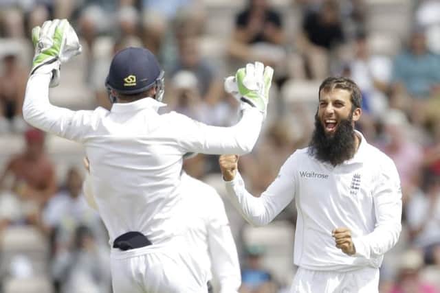 Englands Moeen Ali, right, celebrates with Jos Buttler after dismissing Bhuvneshwar Kumar. Picture: AP