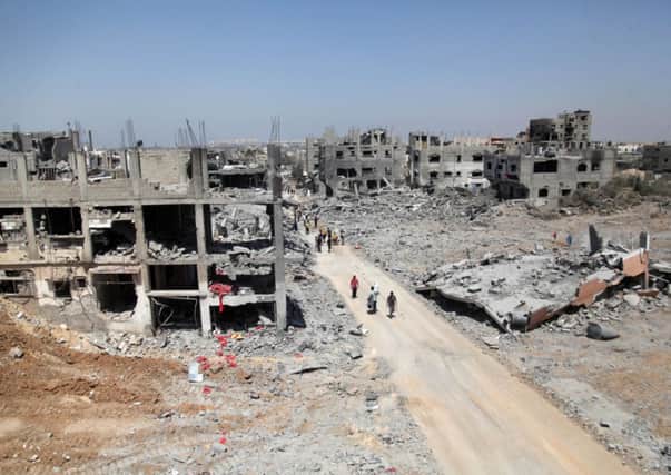 Palestinians inspect the destroyed house in Beit Hanoun , which witnesses said was heavily hit by Israeli shelling and air strikes. Picture: Alamy