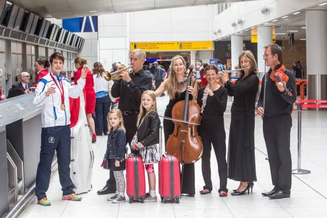 Scottish judo gold medalist Sarah Clark conducts the RSNO at Glasgow Airport. Picture: PA