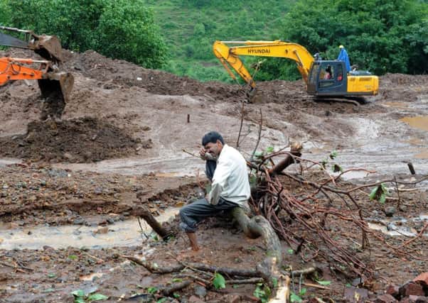 Indian villager Chandrakant Zhanjare, who lost 13 members of his family, breaks down as he sits near the spot which was once his ancestral home. Picture: Getty