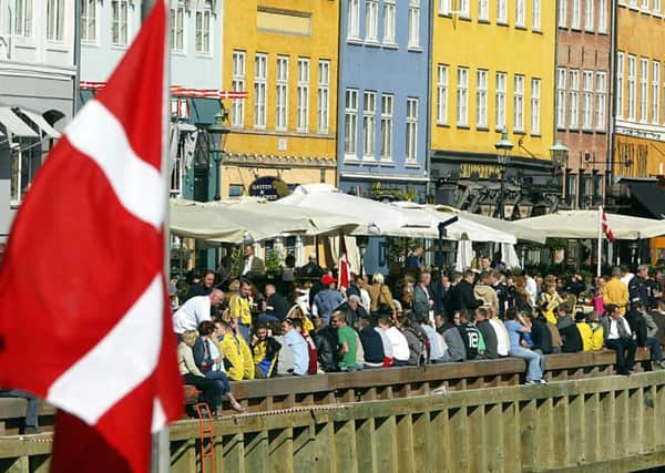 The Danish flag flies over Copenhagen, new research shows Scots are better off than some of our Scandanavian neighbours. Picture: TSPL