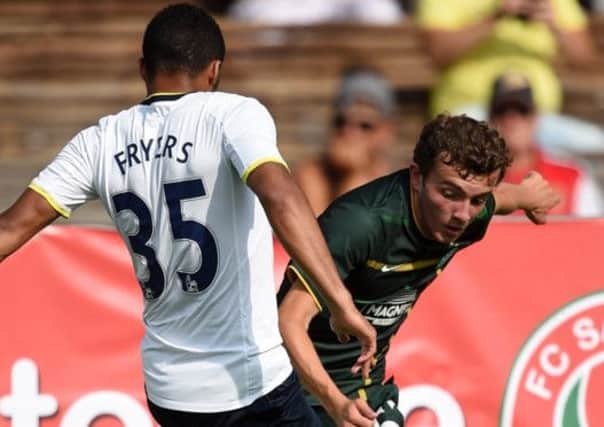 Tottenham Hotspur's Zeki Fryers (L) fights for the ball with Celtic's Paul McMullan. Picture: Reuters