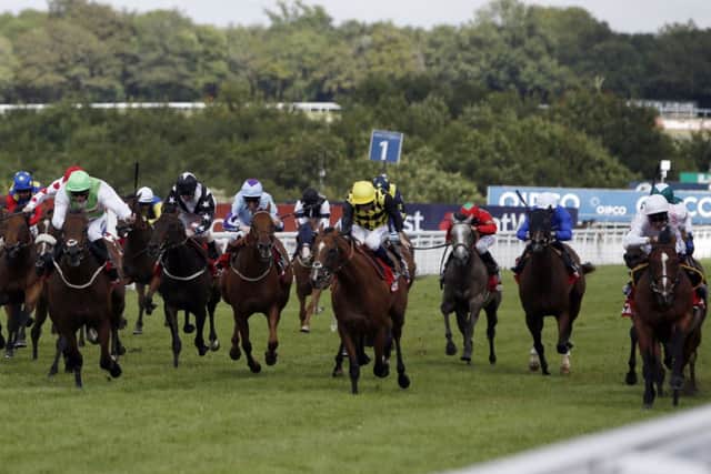 Intrinsic (right) ridden by Richard Hughes wins the 32Red Cup. Picture: PA