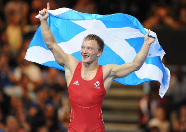 Alex Gladkov of Scotland celebrates a Bronze medal, one of 53 in total won by the hosts. Picture: Neil Hanna