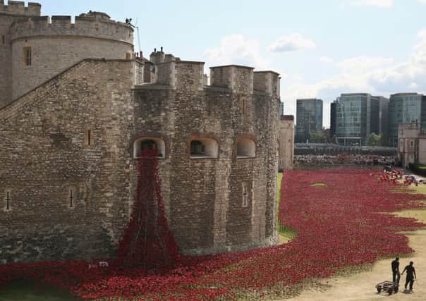 Volunteers assemble an installation entitled 'Blood Swept Lands and Seas of Red' at the Tower of London. Picture: Getty