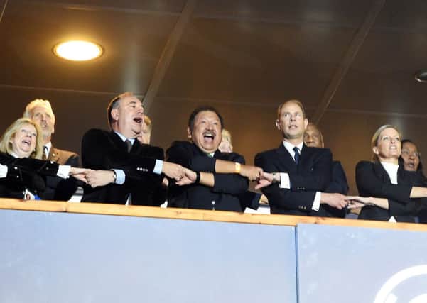 Alex Salmond (left) joins HRH Prince Tunku Imran (centre) and Prince Edward Earl of Wessex as they sing Auld Lang Syne. Picture: SNS