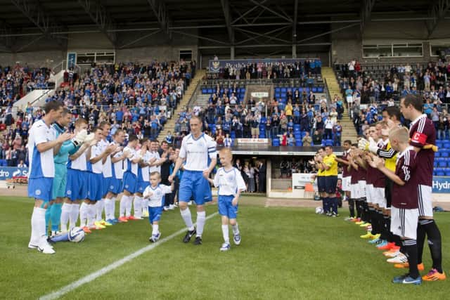 St Johnstone ace Steven Anderson exits the tunnel alongside his sons. Picture: SNS