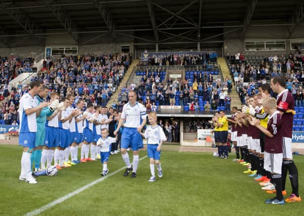 St Johnstone ace Steven Anderson exits the tunnel alongside his sons. Picture: SNS