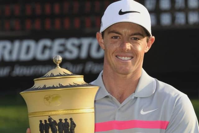 Rory McIlroy, of Northern Ireland, poses with the championship trophy after winning the Bridgestone Invitational golf tournament. Picture: Getty