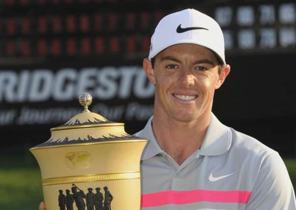 Rory McIlroy, of Northern Ireland, poses with the championship trophy after winning the Bridgestone Invitational golf tournament. Picture: Getty