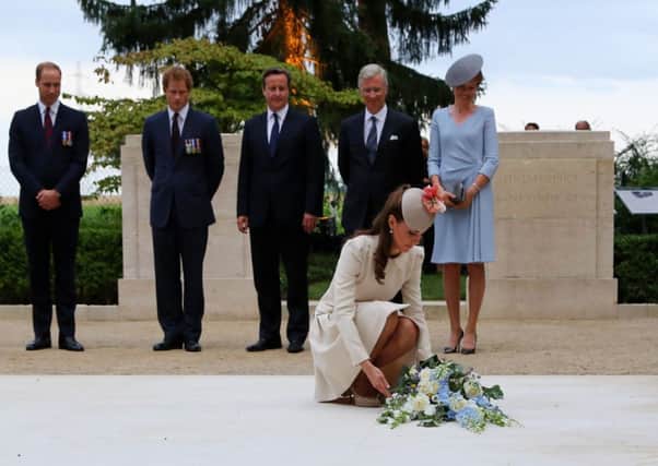 Catherine, Duchess of Cambridge lays flowers as Princes William and Harry look on with David Cameron and King Phillipe and Queen Mathilde of Belgium. Picture: Getty