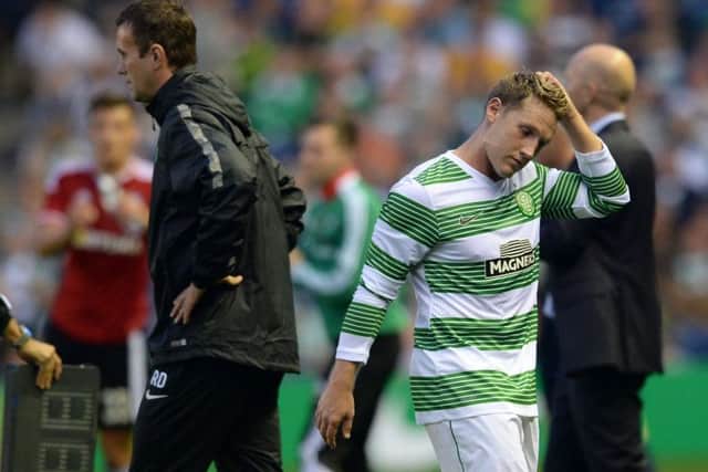 Kris Commons (right) walks past Celtic manager Ronny Deila after being substituted. Picture: SNS