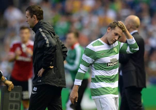 Kris Commons (right) walks past Celtic manager Ronny Deila after being substituted. Picture: SNS