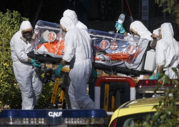 Health workers in Madrid wheel a stretcher carrying Spanish priest Miguel Pajares,75, who has tested positive for Ebola after working in Liberia. Picture: Reuters